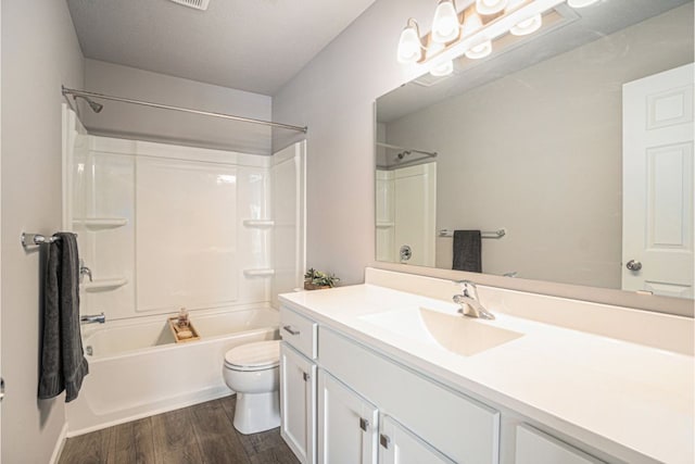 full bathroom with hardwood / wood-style floors, vanity, toilet, and shower / bathing tub combination