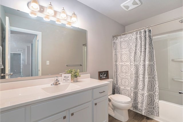 full bathroom featuring shower / tub combo, vanity, hardwood / wood-style flooring, and toilet