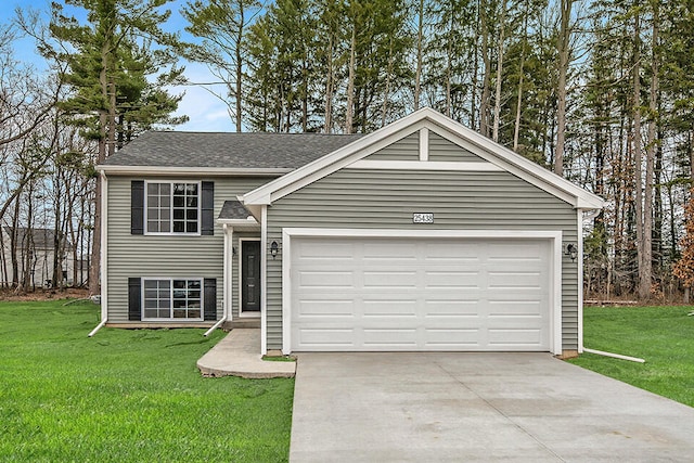 raised ranch with a garage and a front yard