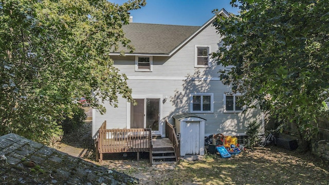 rear view of property featuring a deck