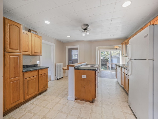 kitchen featuring a center island, white appliances, and radiator heating unit