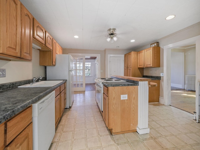 kitchen featuring white appliances, radiator, crown molding, sink, and ceiling fan