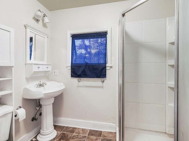 bathroom with tile patterned flooring, toilet, and an enclosed shower