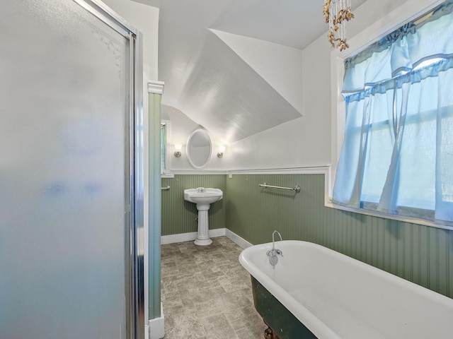 bathroom featuring separate shower and tub and vaulted ceiling