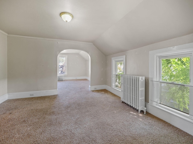 bonus room featuring lofted ceiling, a healthy amount of sunlight, and radiator heating unit