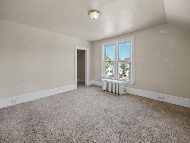 interior space featuring radiator heating unit and lofted ceiling