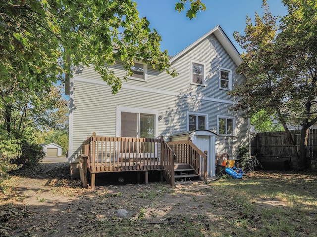 back of property with an outdoor structure and a deck