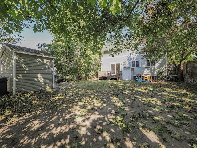 view of yard with a shed and a deck