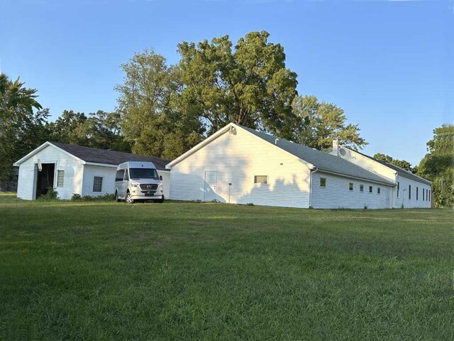 view of property exterior featuring a lawn