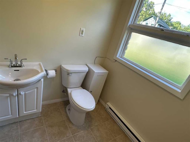 bathroom with tile patterned floors, vanity, a baseboard radiator, and toilet