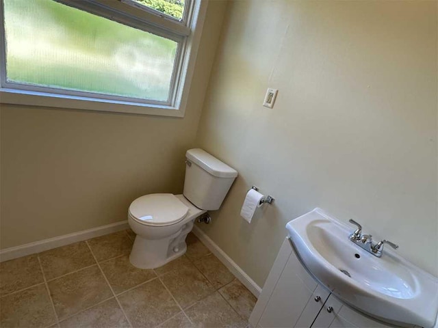 bathroom featuring tile patterned floors, vanity, and toilet