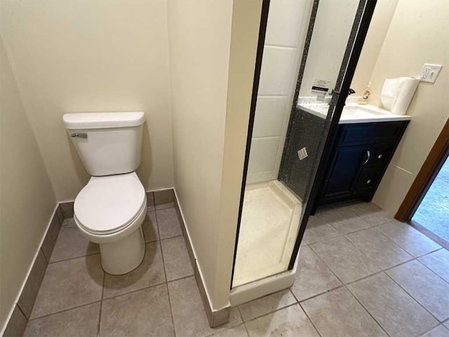 bathroom featuring a shower, tile patterned flooring, vanity, and toilet