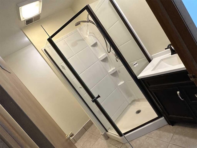 bathroom featuring vanity, tile patterned floors, and a shower with door