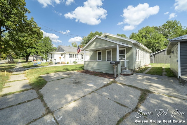 bungalow-style home with a front yard and a porch