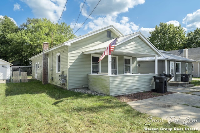 bungalow with a porch and a front lawn