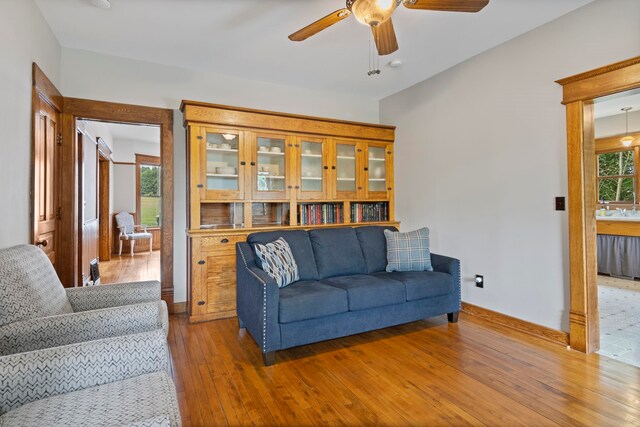5721 Broomhead Rd, Williamsburg, MI 49690 - living room with ceiling fan, hardwood / wood-style floors, and baseboards