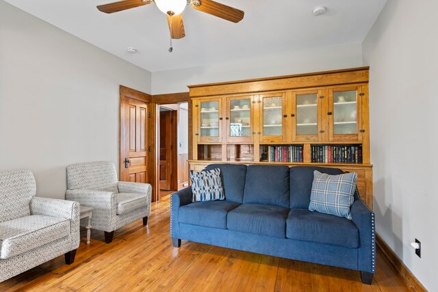 5721 Broomhead Rd, Williamsburg, MI 49690 - living room featuring a ceiling fan, hardwood / wood-style flooring, and baseboards