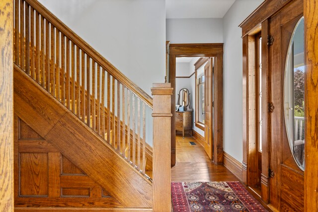 5721 Broomhead Rd, Williamsburg, MI 49690 - foyer entrance with wood-type flooring, stairs, baseboards, and french doors