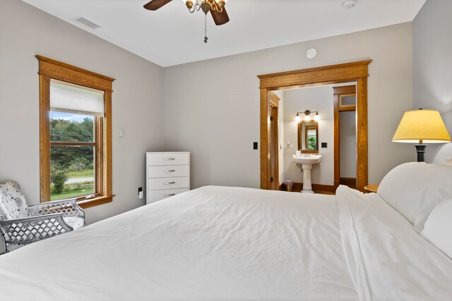 5721 Broomhead Rd, Williamsburg, MI 49690 - bedroom featuring ensuite bath and a ceiling fan