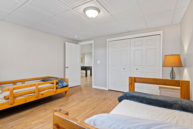 5721 Broomhead Rd, Williamsburg, MI 49690 - bedroom featuring wood finished floors, baseboards, and a closet