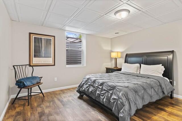 5721 Broomhead Rd, Williamsburg, MI 49690 - bedroom featuring wood finished floors, baseboards, and an ornate ceiling