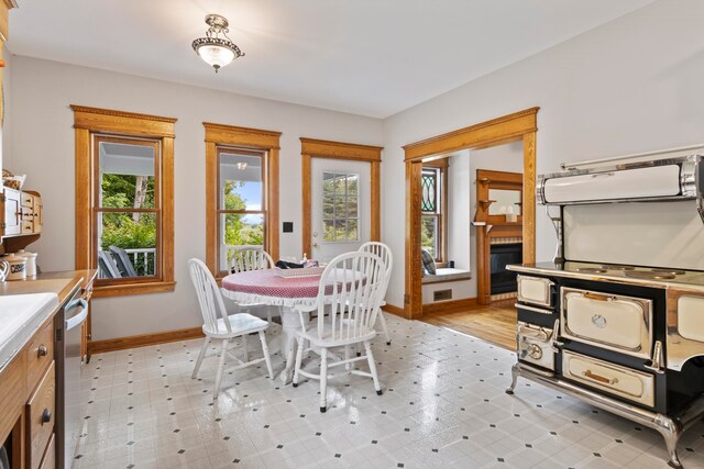 5721 Broomhead Rd, Williamsburg, MI 49690 - dining area with baseboards, a fireplace, and light flooring