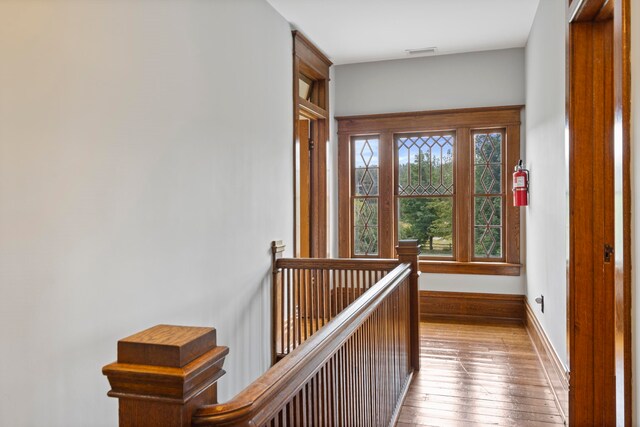 5721 Broomhead Rd, Williamsburg, MI 49690 - corridor with an upstairs landing, wood-type flooring, and baseboards