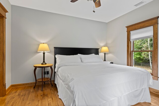 5721 Broomhead Rd, Williamsburg, MI 49690 - bedroom with light wood-style floors, baseboards, and ceiling fan