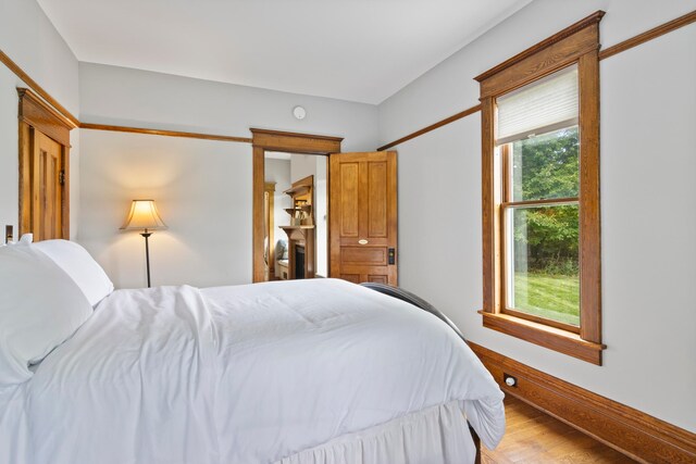 5721 Broomhead Rd, Williamsburg, MI 49690 - bedroom featuring light wood-style floors and baseboards