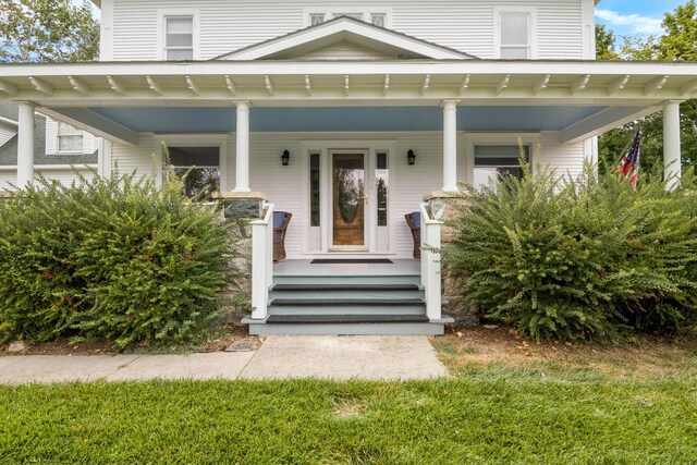 5721 Broomhead Rd, Williamsburg, MI 49690 - doorway to property featuring covered porch