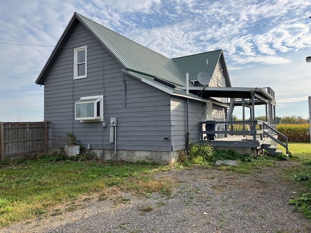 view of property exterior with a wooden deck