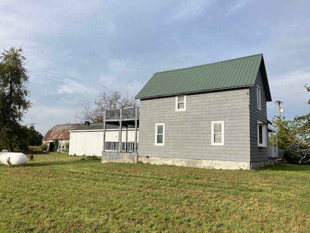 back of property featuring a lawn