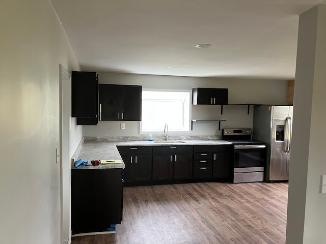 kitchen featuring sink, stainless steel appliances, and light wood-type flooring