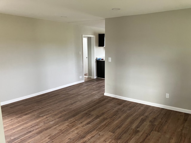 spare room featuring dark hardwood / wood-style floors