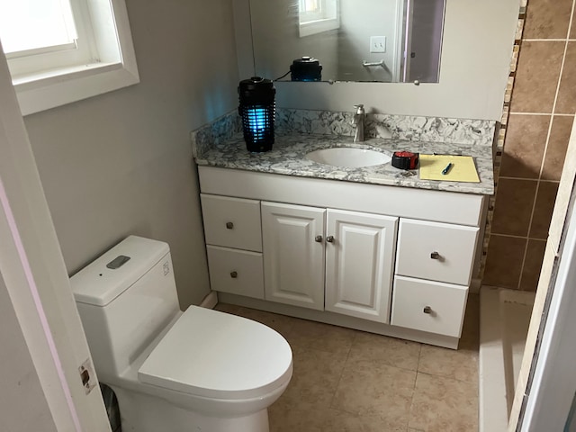 bathroom featuring tile patterned flooring, vanity, and toilet