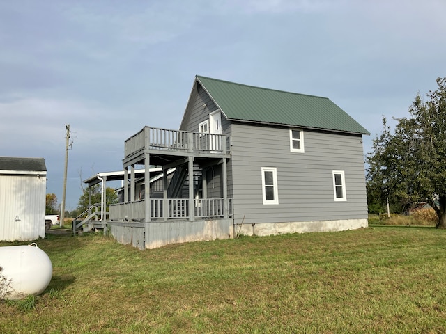 view of side of home featuring a lawn and a deck