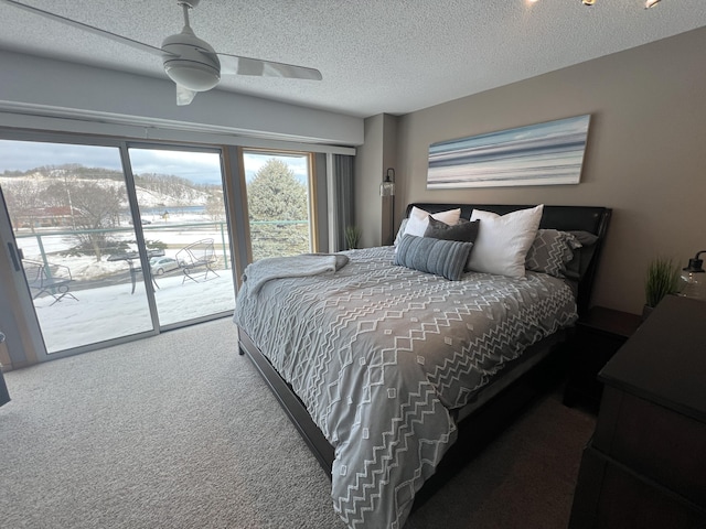 carpeted bedroom with a textured ceiling, ceiling fan, and access to outside