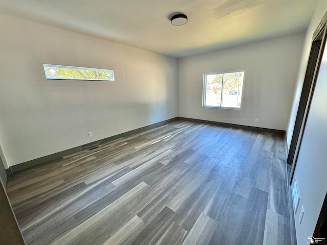 unfurnished room featuring dark hardwood / wood-style floors