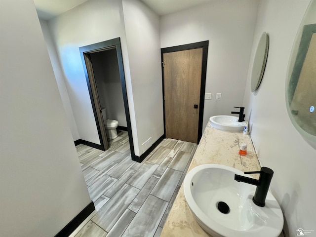 bathroom featuring vanity and toilet