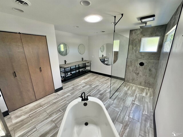 bathroom featuring vanity and tiled shower