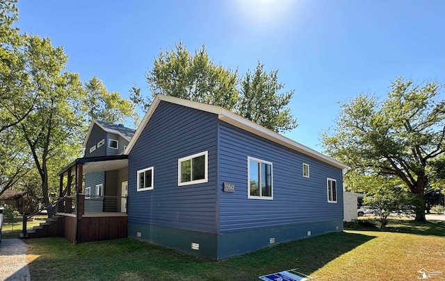 view of side of property with a lawn