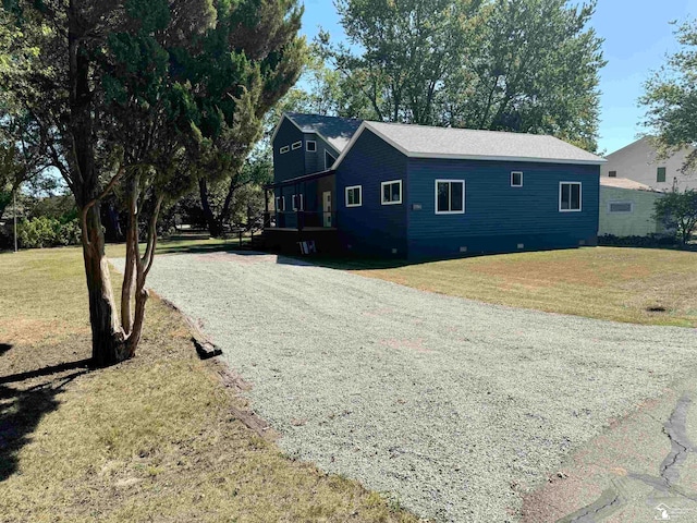 view of side of home with a lawn