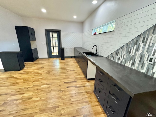 kitchen with dishwasher, light hardwood / wood-style floors, sink, and a wealth of natural light