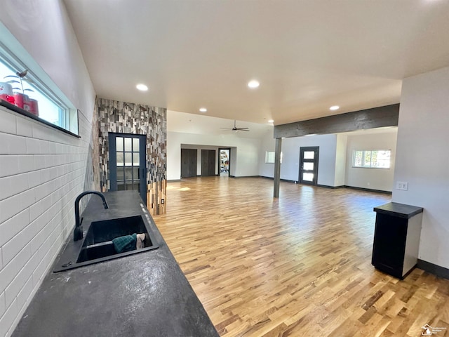 exercise area with hardwood / wood-style floors, ceiling fan, and sink