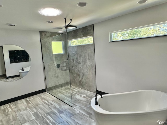 bathroom with shower with separate bathtub