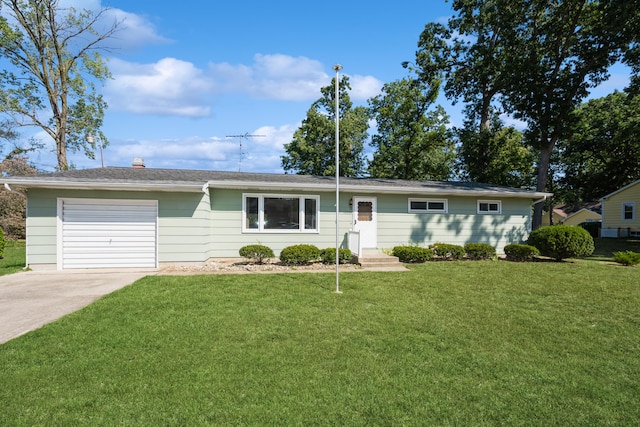 ranch-style house featuring a front lawn and a garage