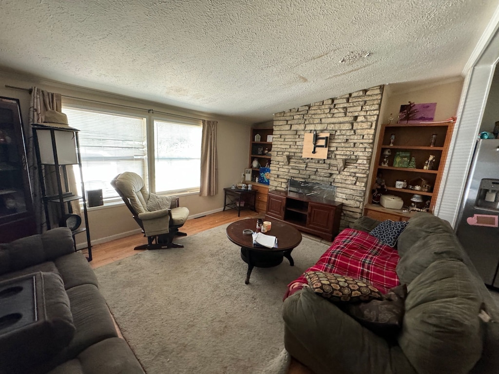 living room with wood-type flooring, a textured ceiling, and vaulted ceiling