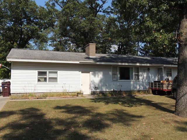 back of property featuring a lawn