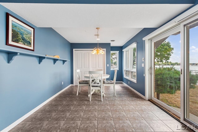 unfurnished dining area featuring a chandelier