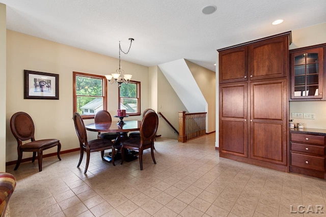 dining area featuring light tile patterned floors and a notable chandelier